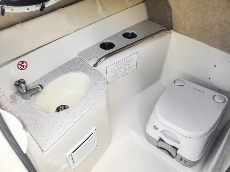 Slide: The Image of 2025 Stingray 211 DC boat interior with sink and portable toilet. - 11