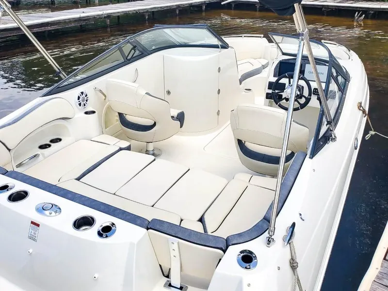 Slide: The Image of 2025 Stingray 211 DC boat interior with beige seating and modern dashboard. - 14