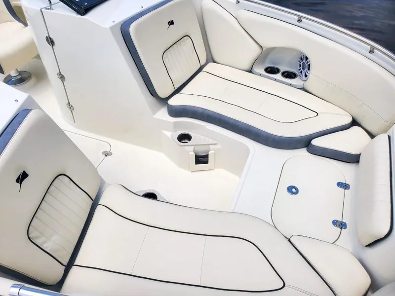 Slide: The Image of Luxurious seating area of 2025 Stingray 211 DC boat with white and gray upholstery. - 16