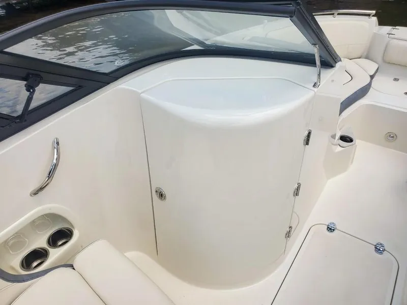 Slide: The Image of 2025 Stingray 211 DC boat interior with cup holders and seating. - 9