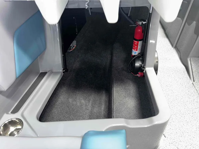 Slide: The Image of 2025 MasterCraft NXT24 interior storage with fire extinguisher and cup holder. - 14