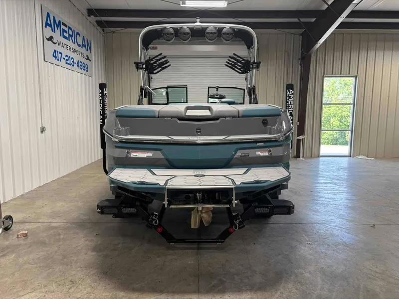 Slide: The Image of 2025 MasterCraft NXT24 boat in showroom, rear view, American Water Sports. - 2