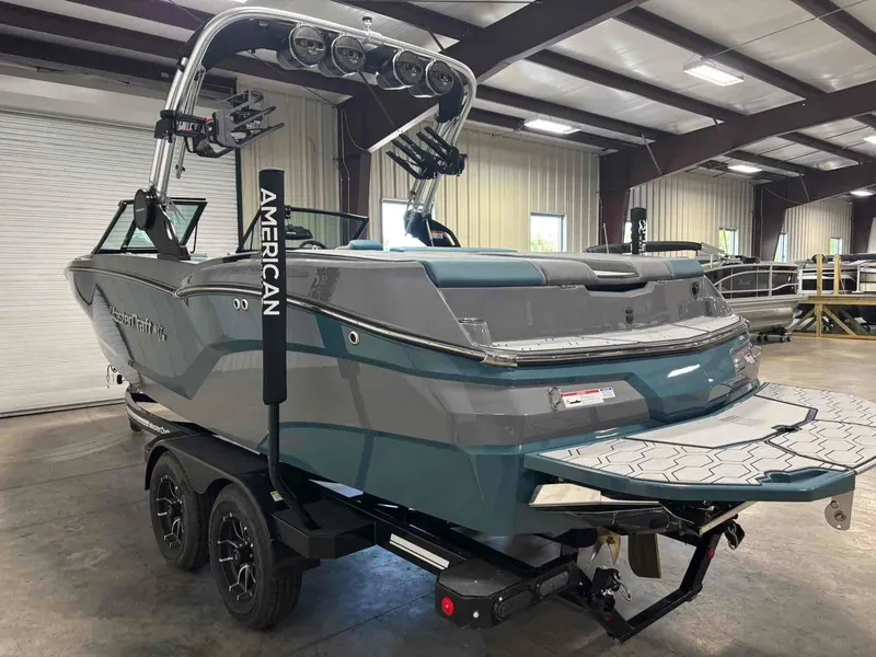 Slide: The Image of 2025 MasterCraft NXT24 boat in a warehouse, showcasing sleek design and modern features. - 3