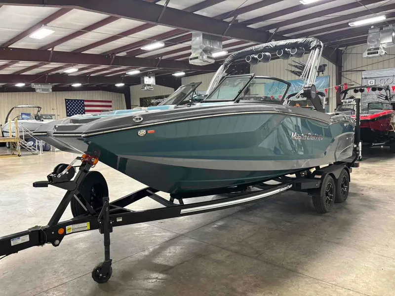 Slide: The Image of 2025 MasterCraft NXT24 boat on trailer in indoor showroom. - 4