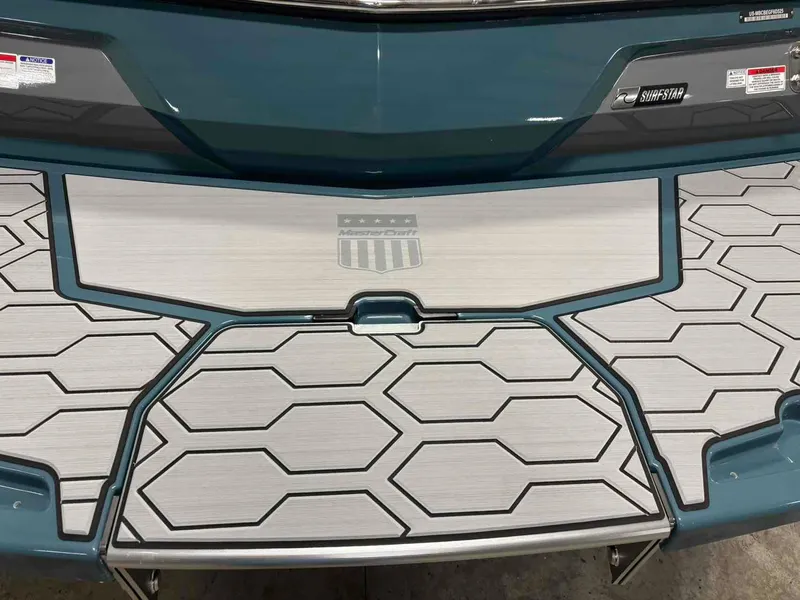 Slide: The Image of 2025 MasterCraft NXT24 boat deck with hexagonal pattern and SurfStar branding. - 6