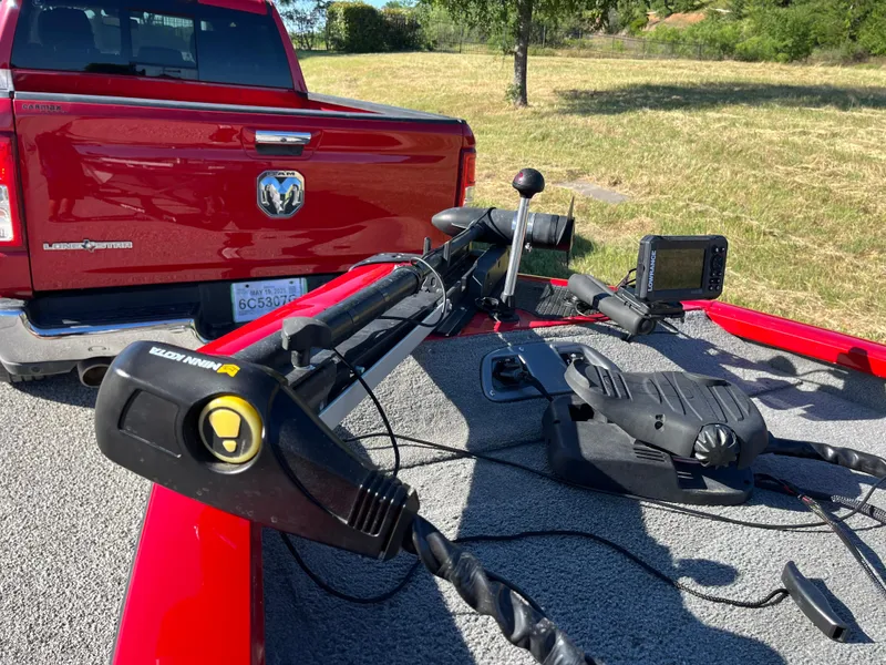 Slide: The Image of 2012 Tracker Pro Team 175 TXW boat with trolling motor and fish finder, parked near red truck. - 10