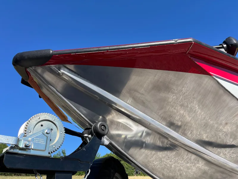 Slide: The Image of 2012 Tracker Pro Team 175 TXW boat on trailer, close-up of bow and winch, under clear blue sky. - 11