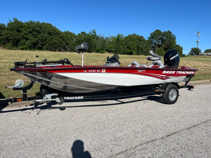 Slide: The Image of 2012 Tracker Pro Team 175 TXW bass boat on trailer, parked outdoors. - 12
