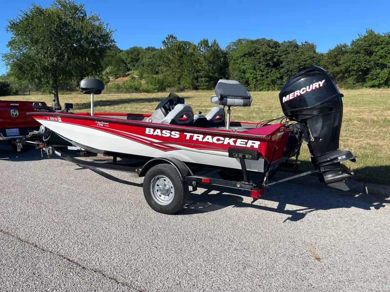Slide: The Image of 2012 Tracker Pro Team 175 TXW bass boat with Mercury engine on trailer. - 15