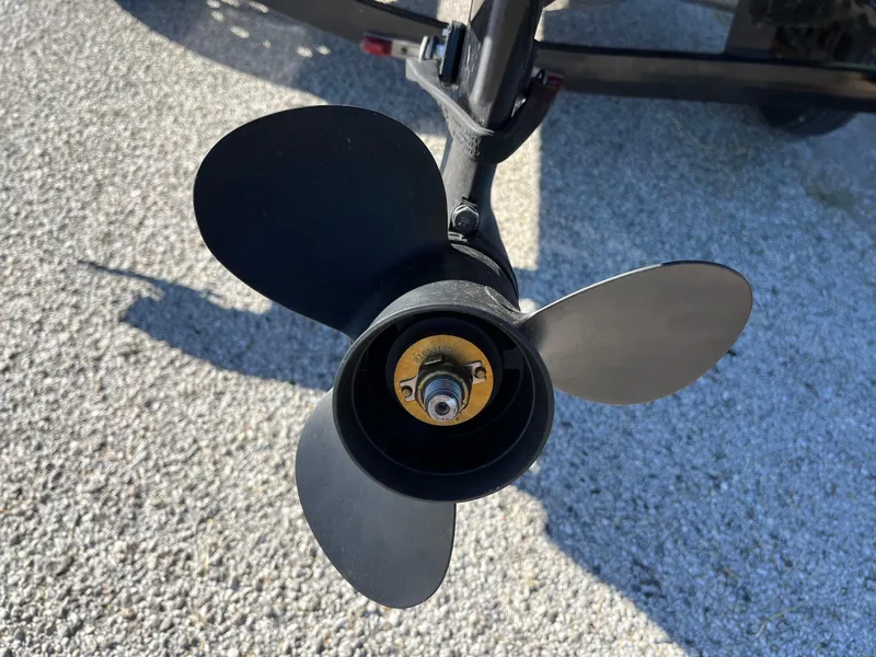 Slide: The Image of Propeller of 2012 Tracker Pro Team 175 TXW boat on pavement background. - 22