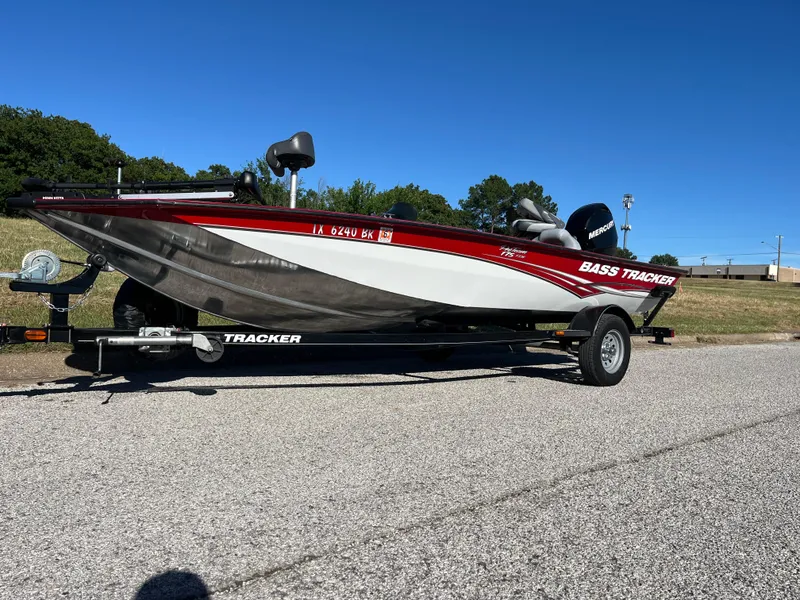 Slide: The Image of 2012 Tracker Pro Team 175 TXW bass boat on trailer, parked on asphalt. - 24