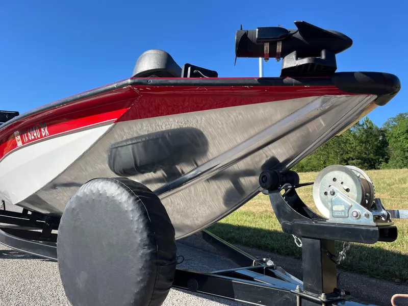 Slide: The Image of 2012 Tracker Pro Team 175 TXW boat on trailer, red and silver, sunny day. - 26