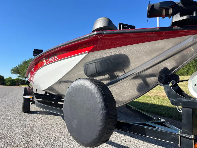Slide: The Image of 2012 Tracker Pro Team 175 TXW boat on trailer, red and silver, parked on road. - 27