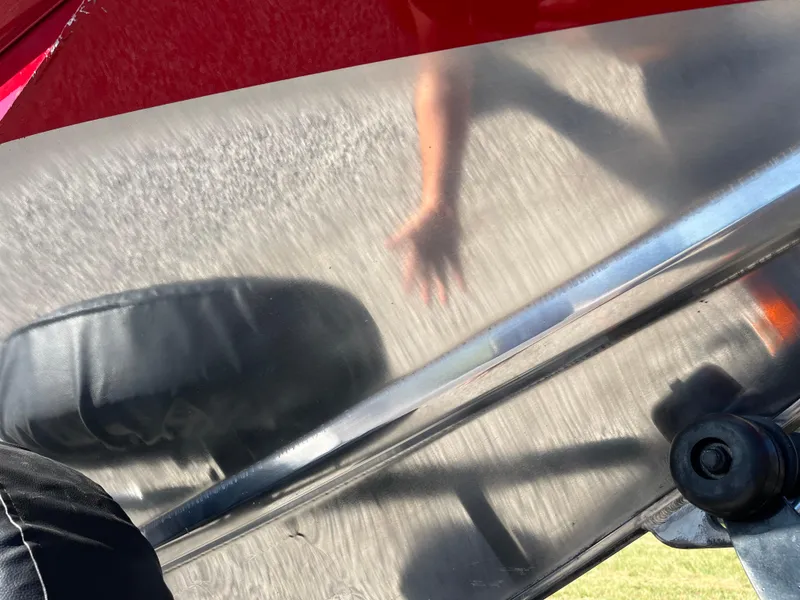 Slide: The Image of Reflection on 2012 Tracker Pro Team 175 TXW boat surface with hand and shadow. - 28