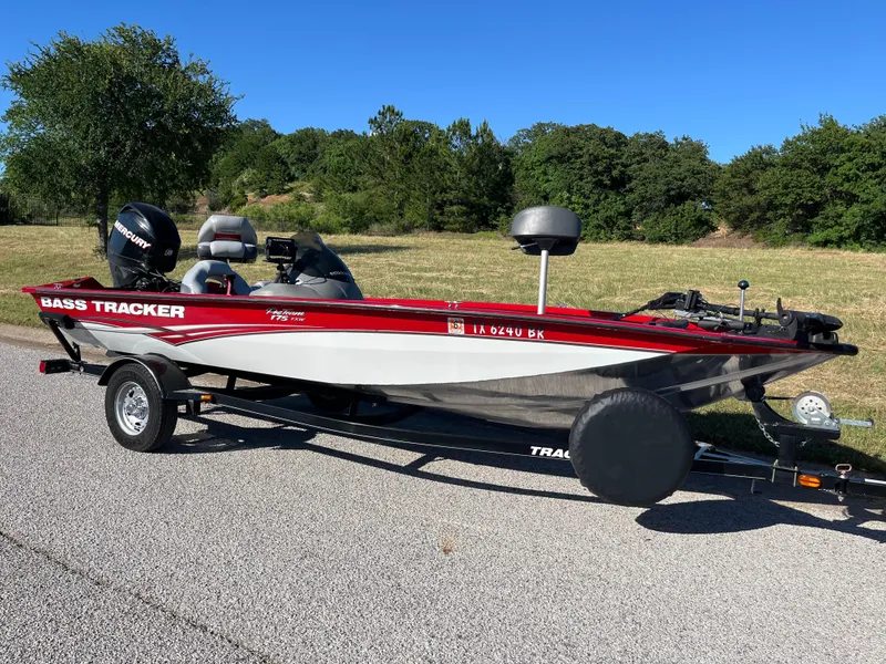 Slide: The Image of 2012 Tracker Pro Team 175 TXW bass boat on trailer, parked on roadside. - 32