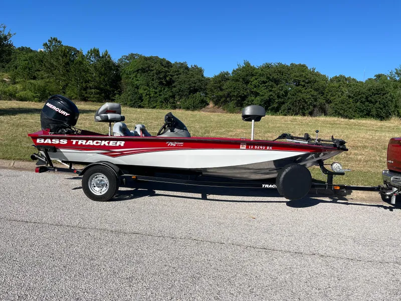 Slide: The Image of 2012 Tracker Pro Team 175 TXW bass boat on trailer, parked on roadside. - 33