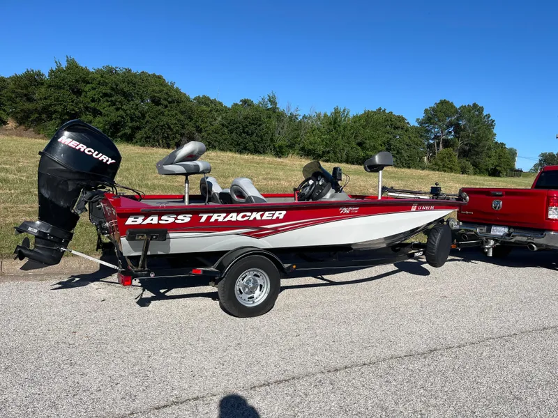 Slide: The Image of 2012 Tracker Pro Team 175 TXW bass boat on trailer, parked on roadside. - 35