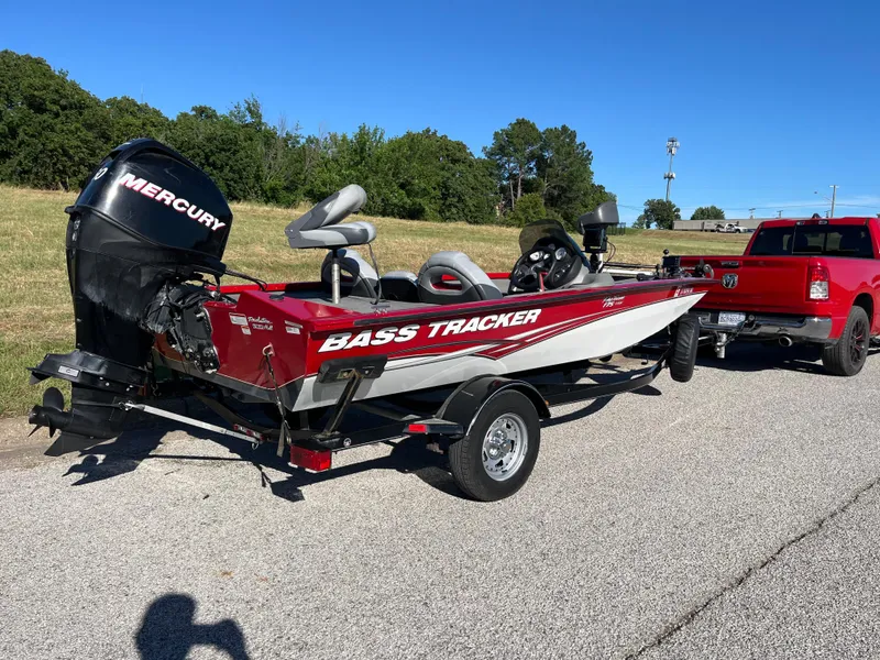 Slide: The Image of 2012 Tracker Pro Team 175 TXW boat with Mercury engine, towed by a red truck. - 36