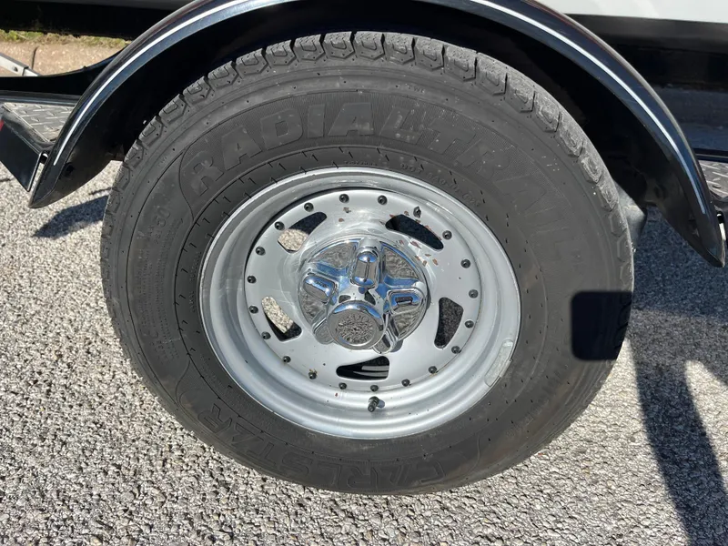 Slide: The Image of 2012 Tracker Pro Team 175 TXW trailer wheel on asphalt surface. - 38