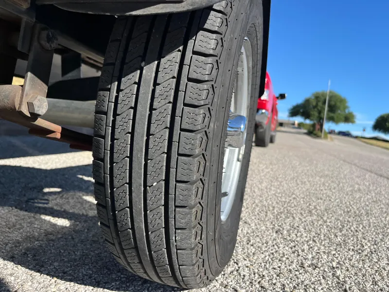 Slide: The Image of Close-up of a 2012 Tracker Pro Team 175 TXW trailer tire on a sunny day. - 39