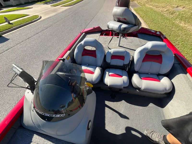 Slide: The Image of 2012 Tracker Pro Team 175 TXW boat interior with seating and console on a sunny day. - 47