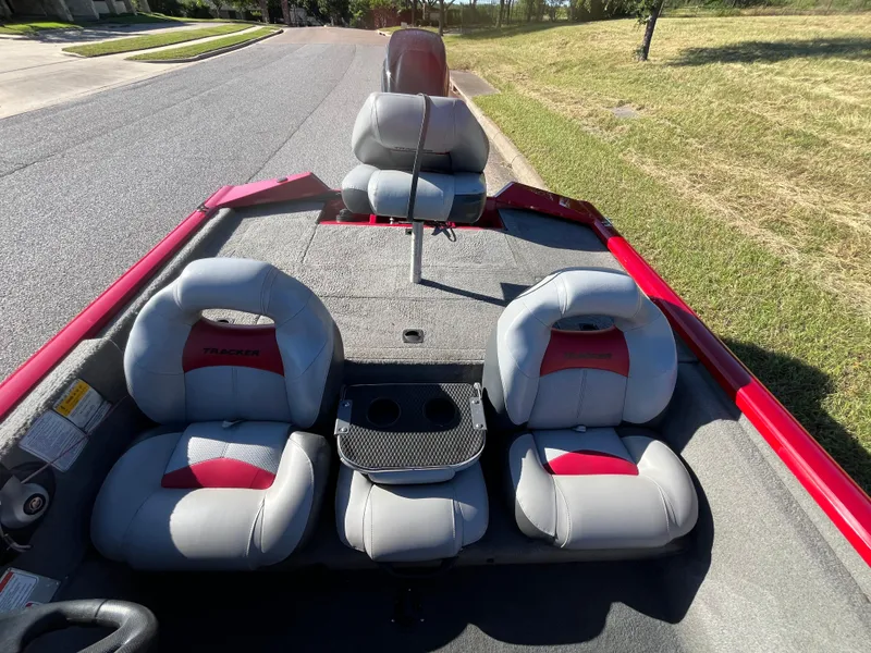 Slide: The Image of 2012 Tracker Pro Team 175 TXW boat with gray and red seating, parked on a street. - 49
