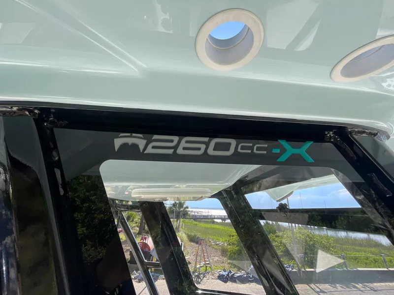 Slide: The Image of 2023 World Cat 260 CC-X boat detail with logo and outdoor background. - 11