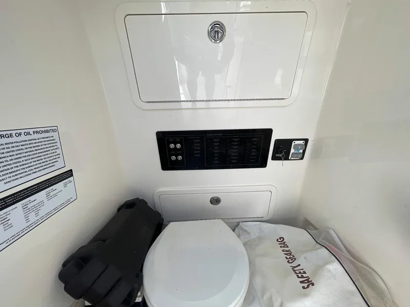 Slide: The Image of 2023 World Cat 260 CC-X boat interior with toilet and safety gear. - 16