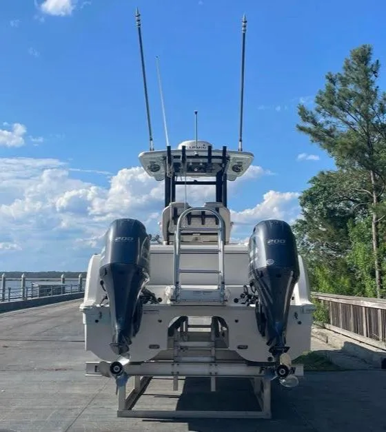 Slide: The Image of 2023 World Cat 260 CC-X boat with dual engines, docked under a clear blue sky. - 3