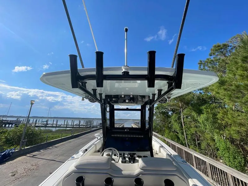 Slide: The Image of 2023 World Cat 260 CC-X boat with T-top, docked near a scenic waterfront. - 8