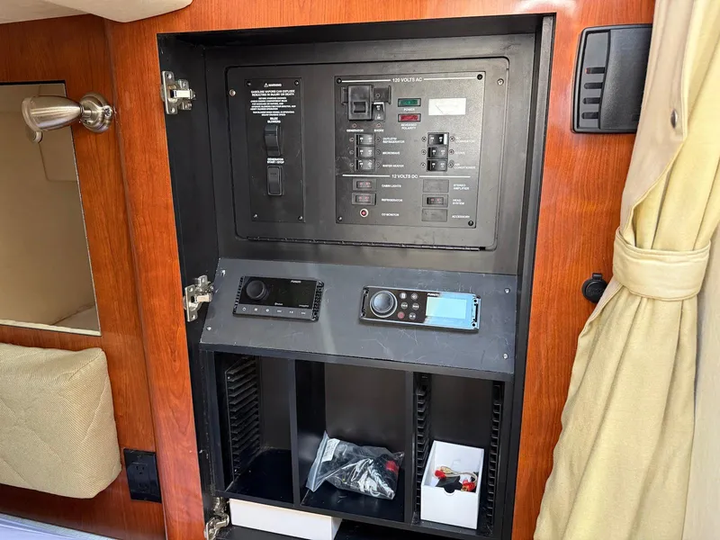 Slide: The Image of Electrical control panel inside 2007 Sea Ray 280 Sundancer boat cabin. - 13