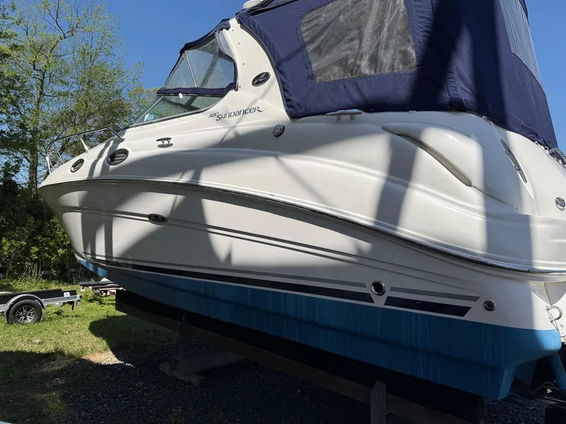 Slide: The Image of 2007 Sea Ray 280 Sundancer boat on trailer, blue canopy, parked outdoors. - 5