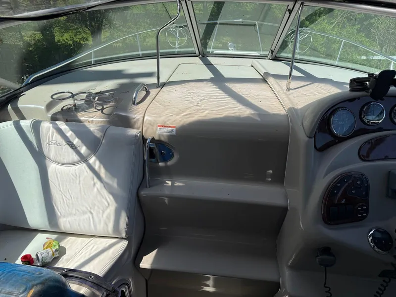 Slide: The Image of 2007 Sea Ray 280 Sundancer cockpit with steering wheel, gauges, and seating in sunlight. - 6