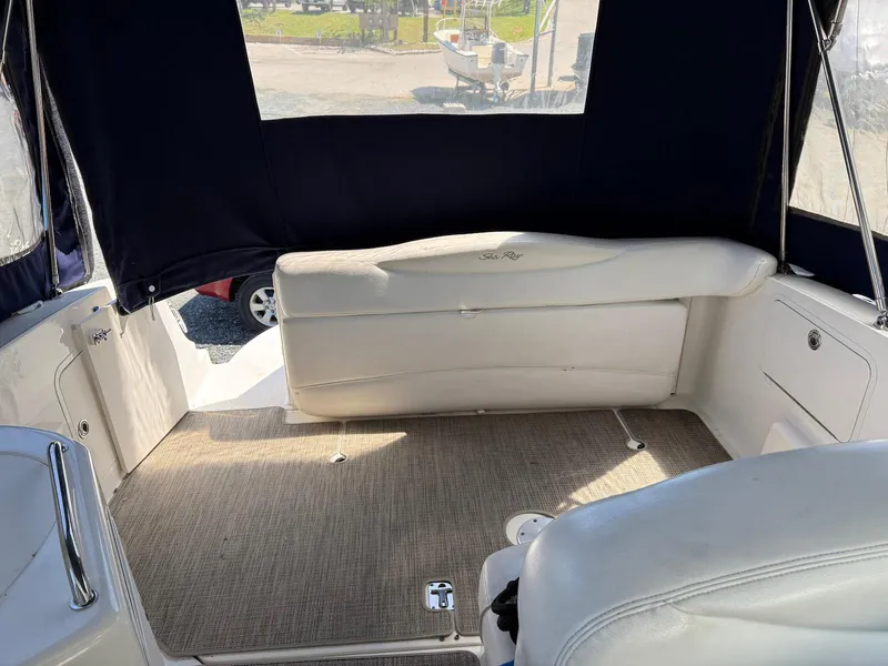 Slide: The Image of 2007 Sea Ray 280 Sundancer boat interior with cushioned seating and carpeted floor. - 7