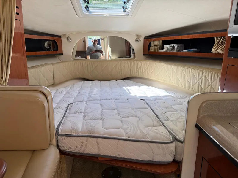 Slide: The Image of Interior cabin of 2007 Sea Ray 280 Sundancer with bed and storage shelves. - 9