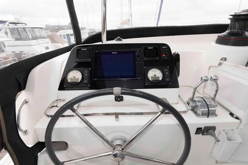 Slide: The Image of Steering wheel and control panel of a 2019 Lagoon 42 catamaran. - 13
