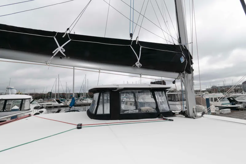 Slide: The Image of 2019 Lagoon 42 catamaran docked at marina, featuring sleek design and modern rigging. - 21