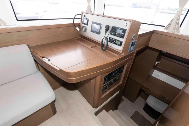 Slide: The Image of 2019 Lagoon 42 yacht interior with navigation station and wooden finish. - 27
