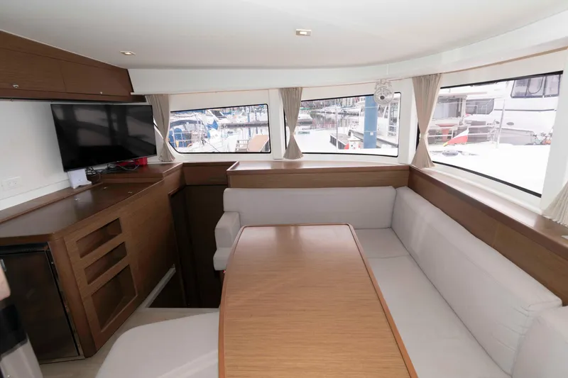 Slide: The Image of Interior of 2019 Lagoon 42 yacht with dining area and panoramic windows. - 29