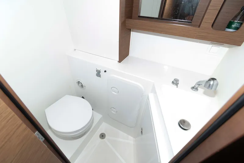 Slide: The Image of Compact bathroom in a 2019 Lagoon 42 yacht, featuring modern fixtures and wood accents. - 37