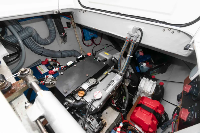 Slide: The Image of Engine compartment of a 2019 Lagoon 42 catamaran, showcasing mechanical components and wiring. - 43