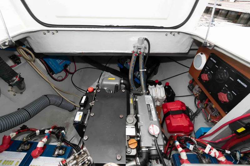 Slide: The Image of Engine compartment of a 2019 Lagoon 42 catamaran, showcasing mechanical components and wiring. - 45