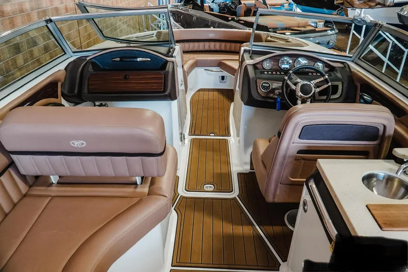 Slide: The Image of 2013 Cobalt A28 boat interior with luxurious seating and modern dashboard design. - 12