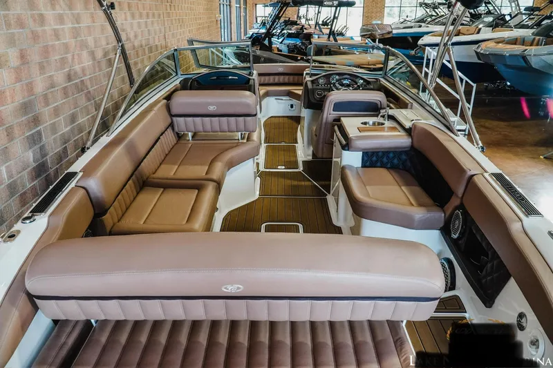 Slide: The Image of 2013 Cobalt A28 boat interior with luxurious brown seating and sleek design. - 13