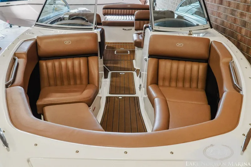 Slide: The Image of 2013 Cobalt A28 boat interior with brown leather seating and wooden flooring. - 17