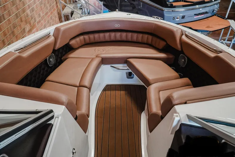 Slide: The Image of 2013 Cobalt A28 boat interior with brown leather seating and wood flooring. - 5