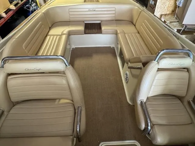 Slide: The Image of 2012 Chris-Craft Launch 28 boat interior with beige leather seating and chrome accents. - 10