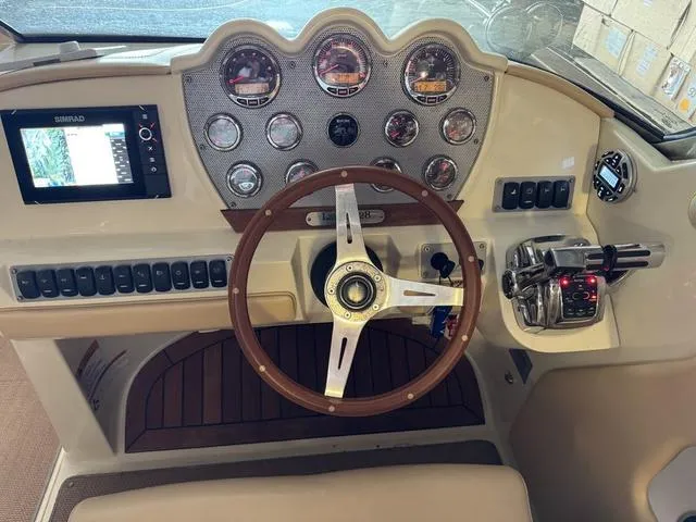 Slide: The Image of 2012 Chris-Craft Launch 28 dashboard with gauges, steering wheel, and navigation system. - 12