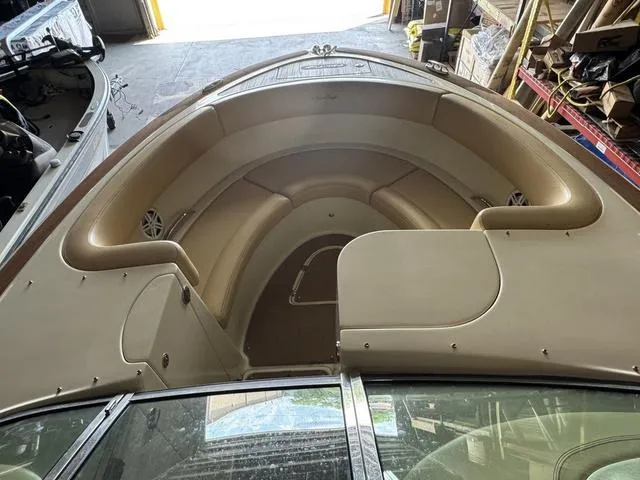 Slide: The Image of 2012 Chris-Craft Launch 28 boat interior with beige seating and storage compartments. - 14