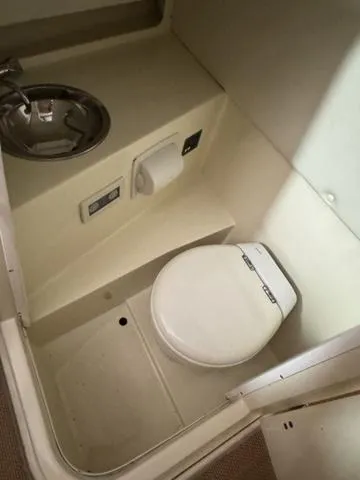 Slide: The Image of 2012 Chris-Craft Launch 28 boat bathroom with toilet and sink. - 16